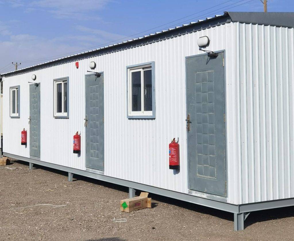 White Three-Room Shinko Cabin with Fire Safety Equipment White three-room shinko prefab cabin equipped with outdoor fire safety equipment and extinguishers