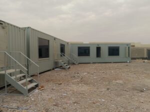 corner view of interconnected gray modular container office units.