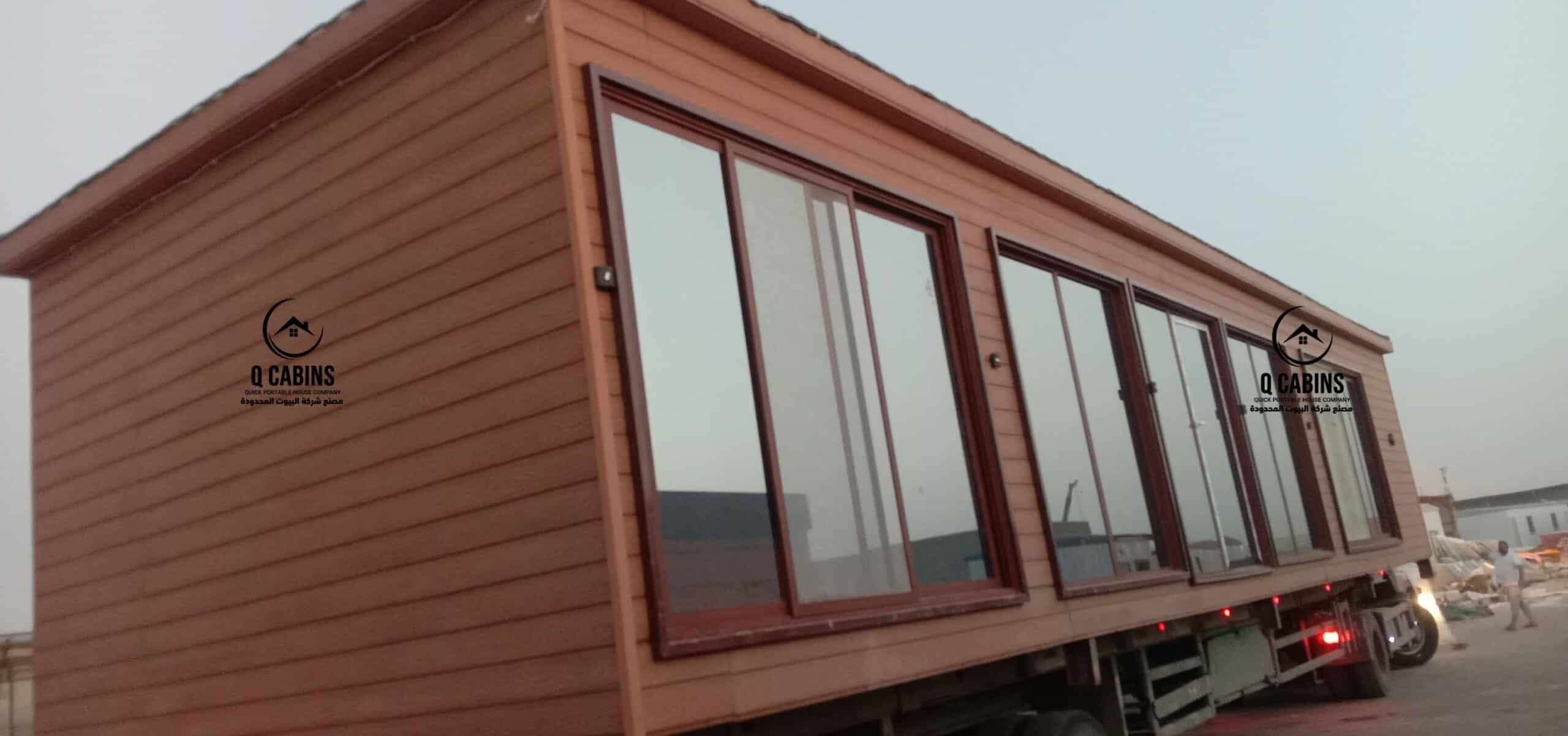 Prefabricated wood-finish cement board cabin unit on flatbed truck