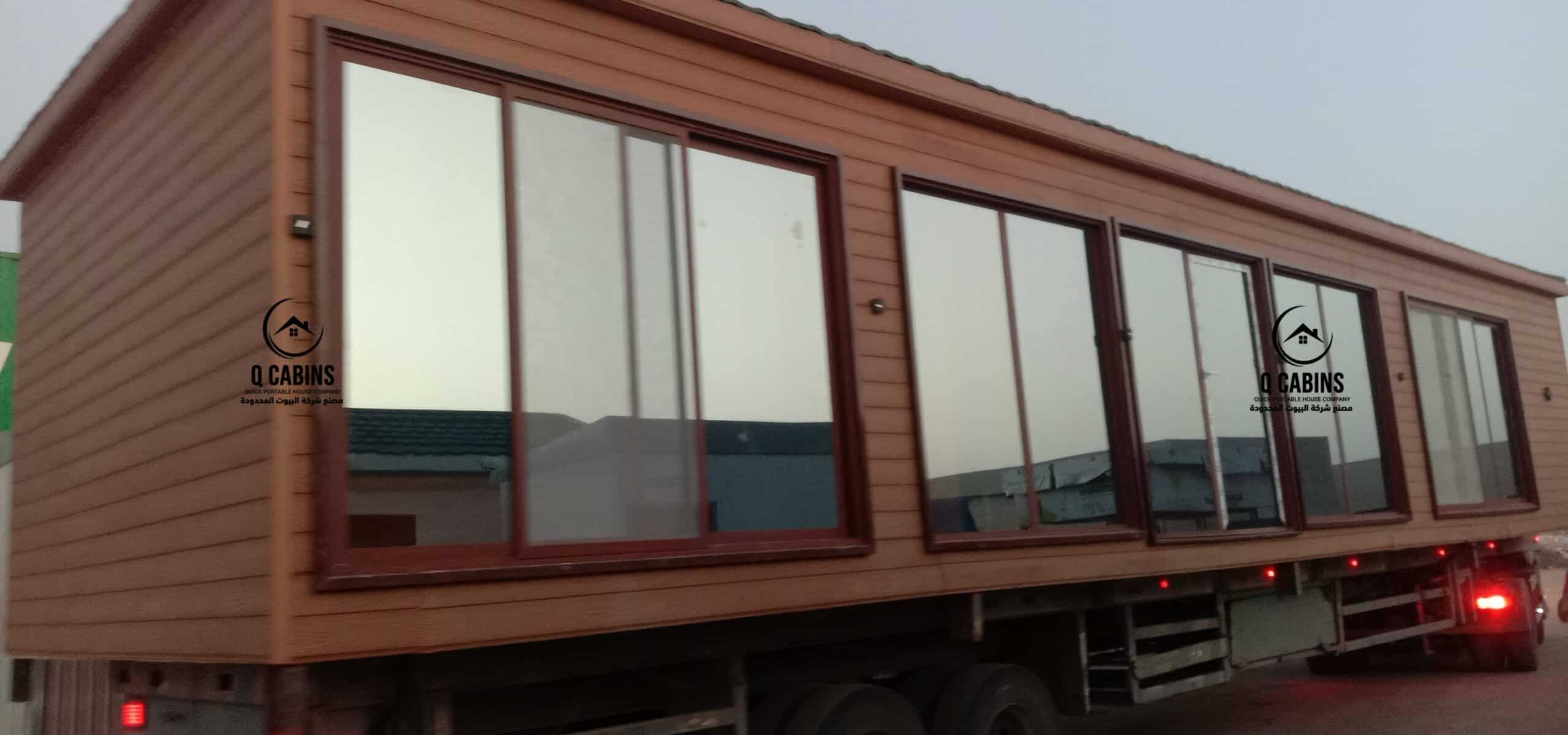 Wood-patterned cement board porta cabin loaded on transport trailer