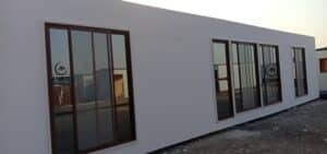 Cement board porta cabin featuring floor-to-ceiling window panels