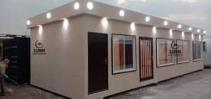 Illuminated cement board porta cabin office with exterior roof spotlights.