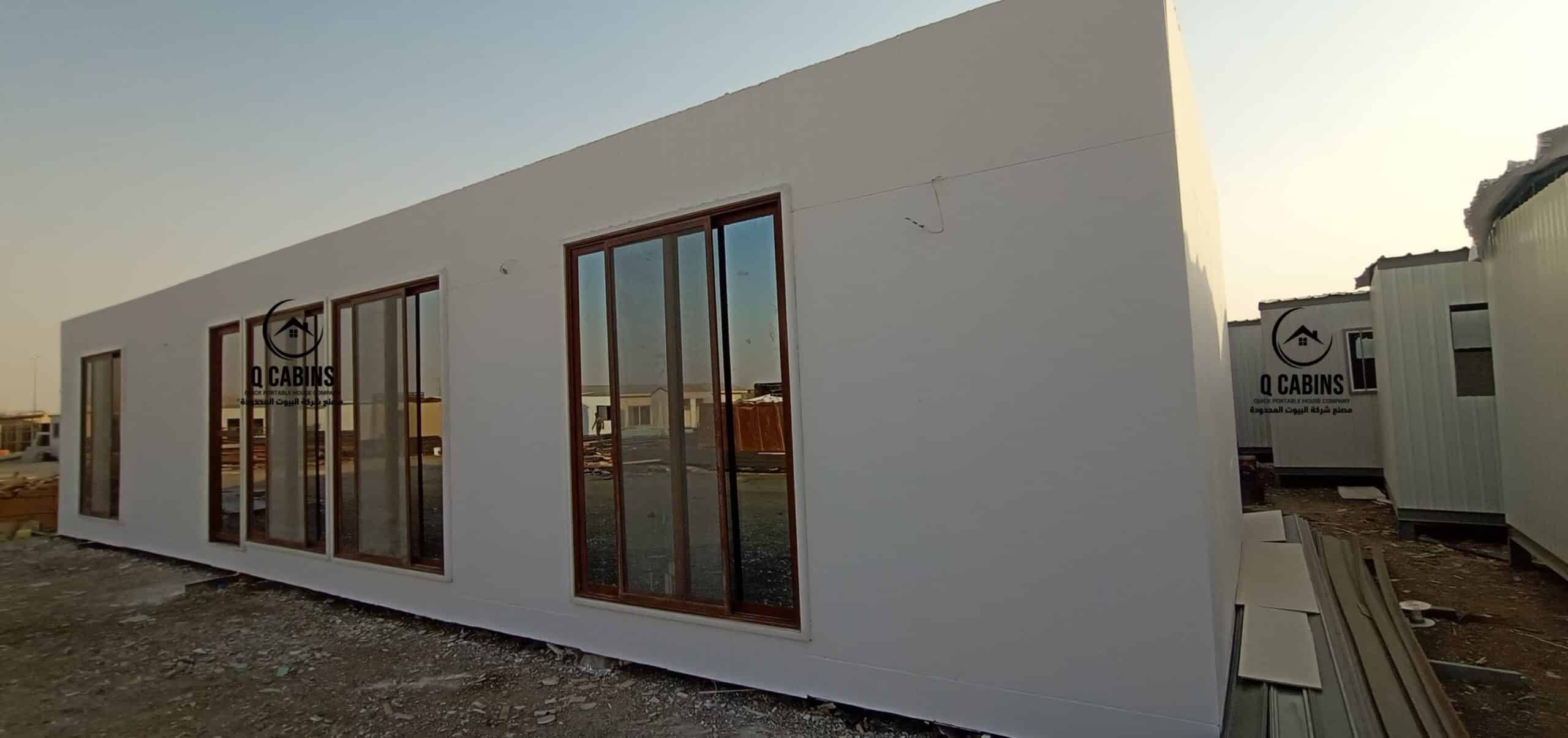 Modern white cement board porta cabin with large sliding glass windows for site offices.