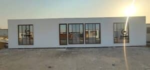 Clean white cement board portable office unit with center glass doors