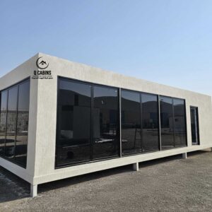 Side angle of white cement board modular porta cabin. with big black windows