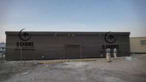 Long dark cladding prefabricated building structure installed at project site