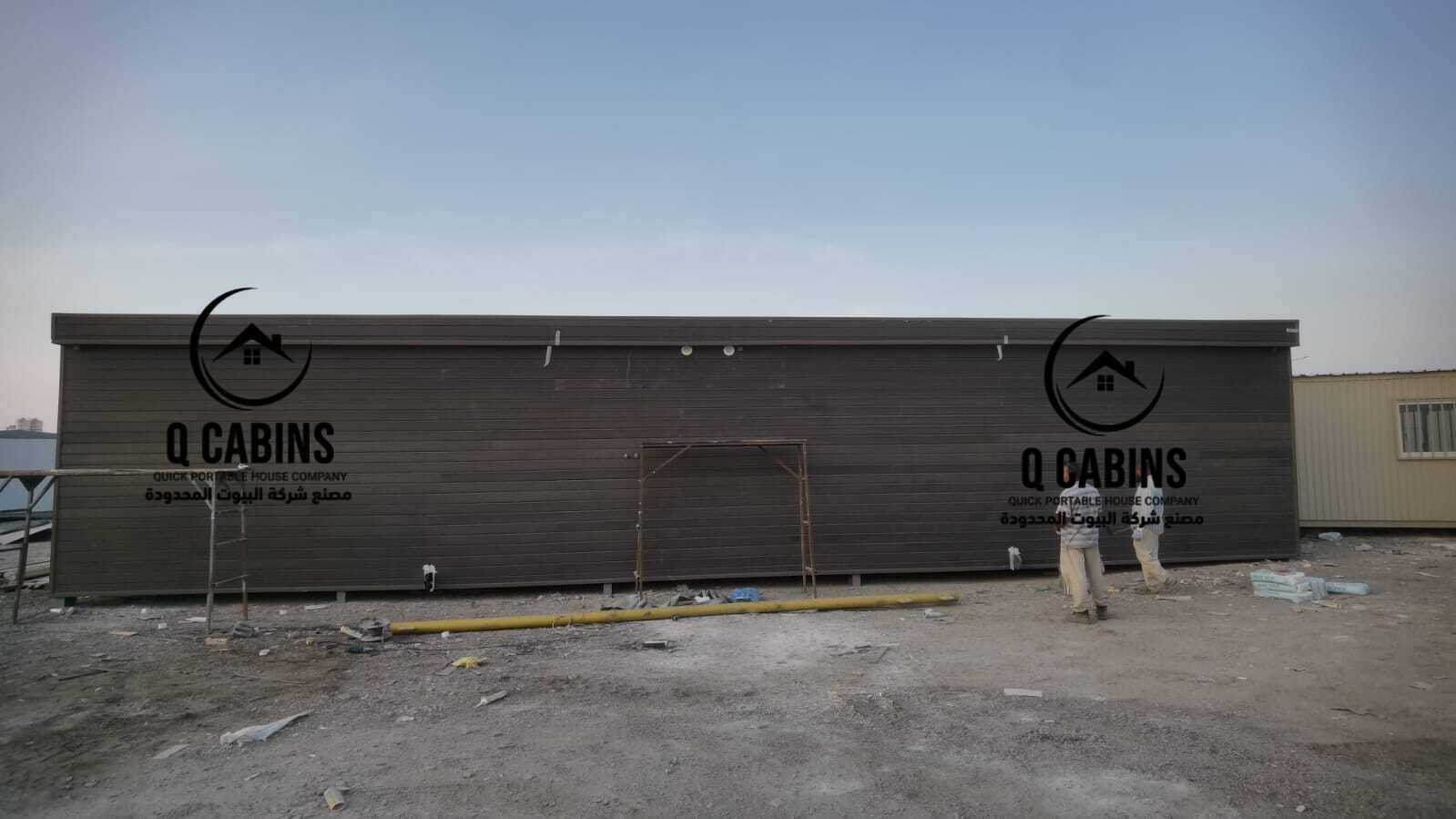 Long dark cladding prefabricated building structure installed at project site