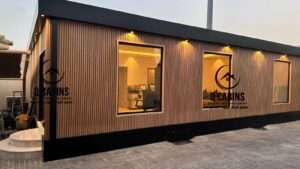 Night illumination view of modern windows on a wood composite cladding prefabricated building