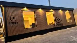 Illuminated glass windows of a premium cladding prefabricated room with exterior warm lights