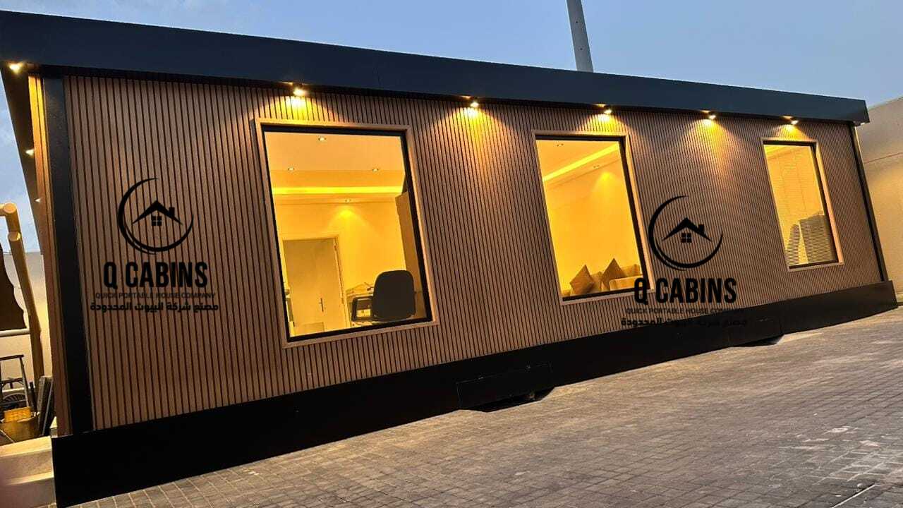 Illuminated glass windows of a premium cladding prefabricated room with exterior warm lights