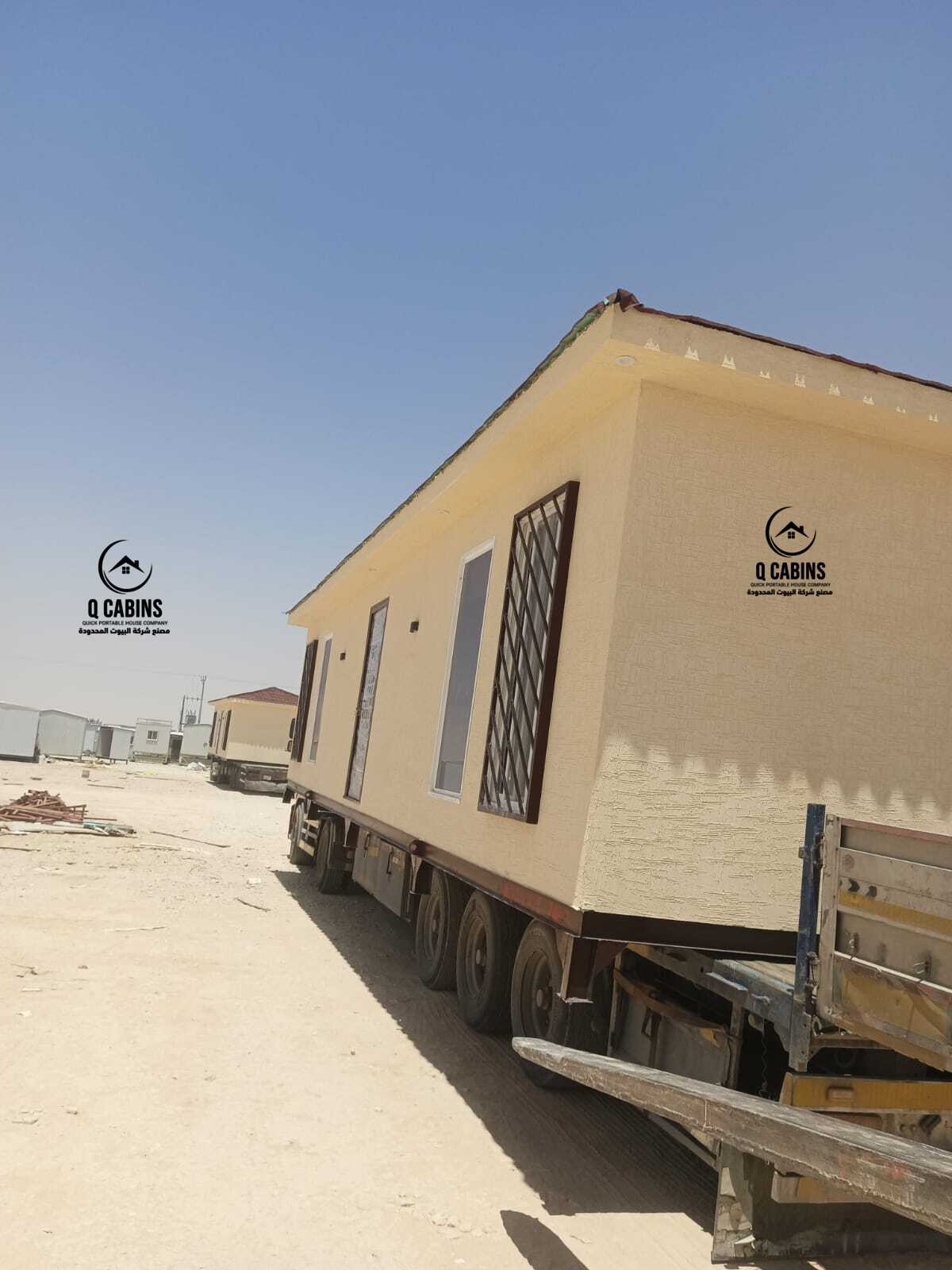 Cement board porta cabin loaded on a transport truck for site delivery.