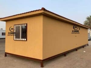 Prefabricated cement board porta cabin featuring a sloping pitched roof design.