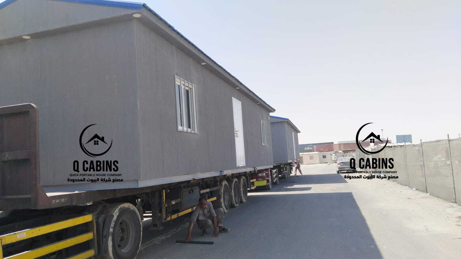 Prefab Cement Board Porta Cabin loaded securely onto a transport flatbed truck