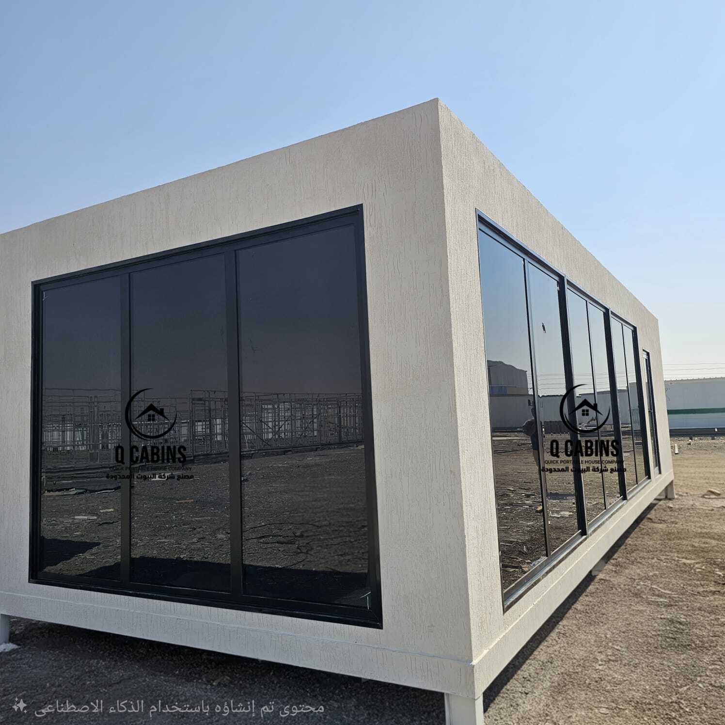 Modern white prefab porta cabins with full glass exterior wall.