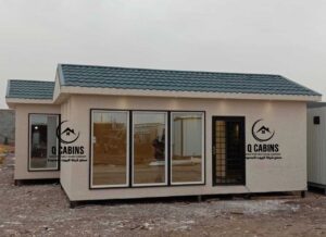 Prefab room with pitched roof and multi-pane windows.