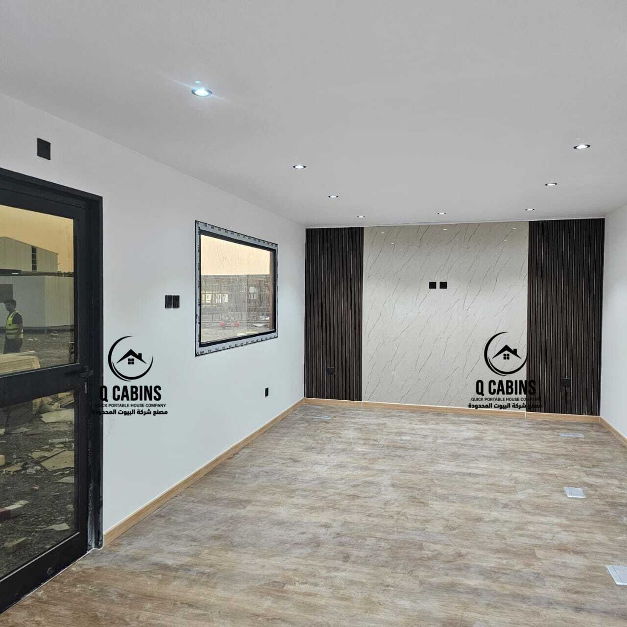 Spacious interior corridor of a modular prefab porta cabin .