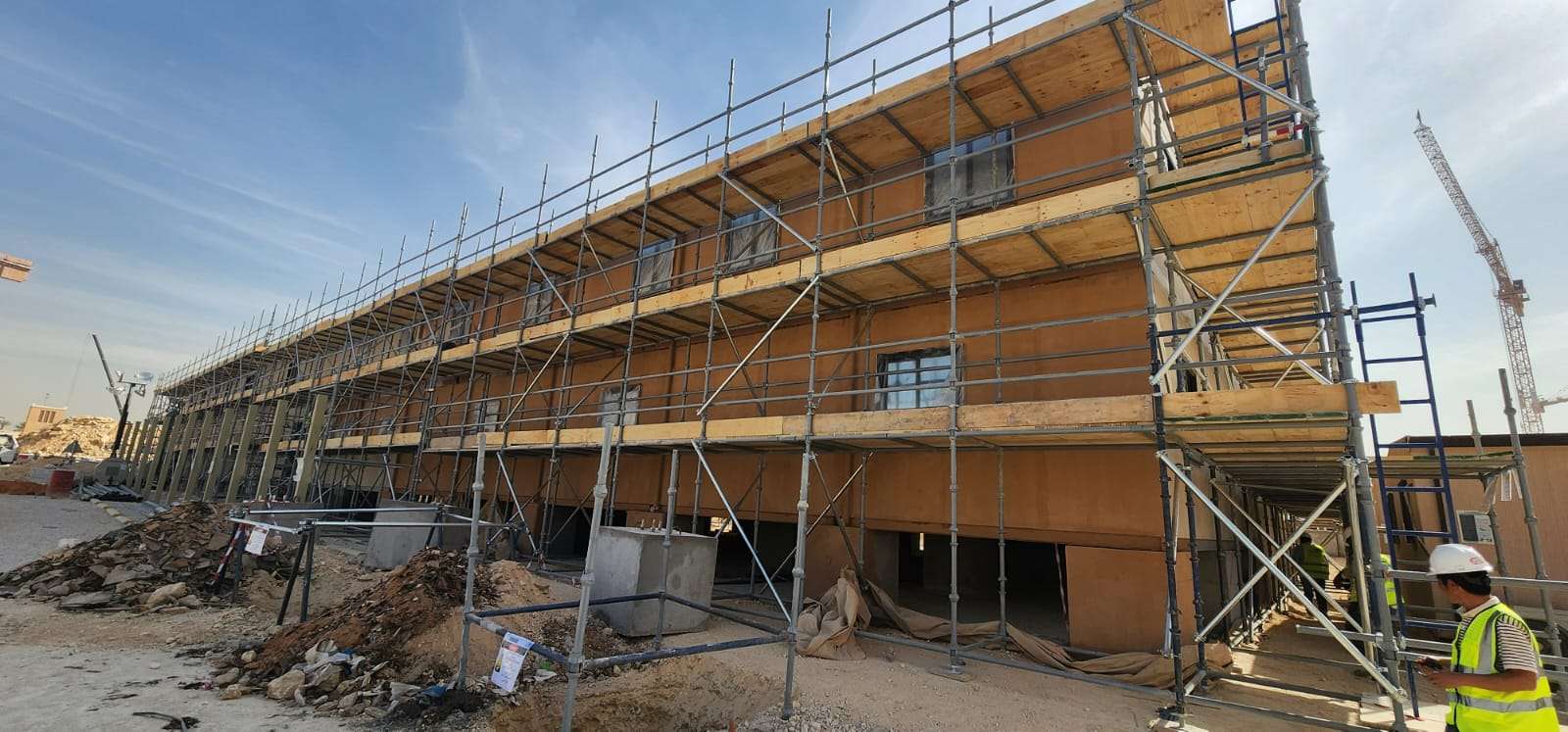 Two-story prefabricated site office construction with scaffolding in Riyadh