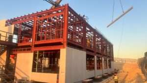 Installation of cladding panels on double-story prefab site office in Riyadh