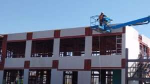 Crane lifting prefabricated modules for two-story site office in Riyadh