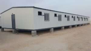 Prefab site office porta cabin on elevated concrete foundation for construction staff in Riyadh