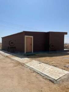 Front facade of a modular prefabricated house with wooden design cladding and entrance door