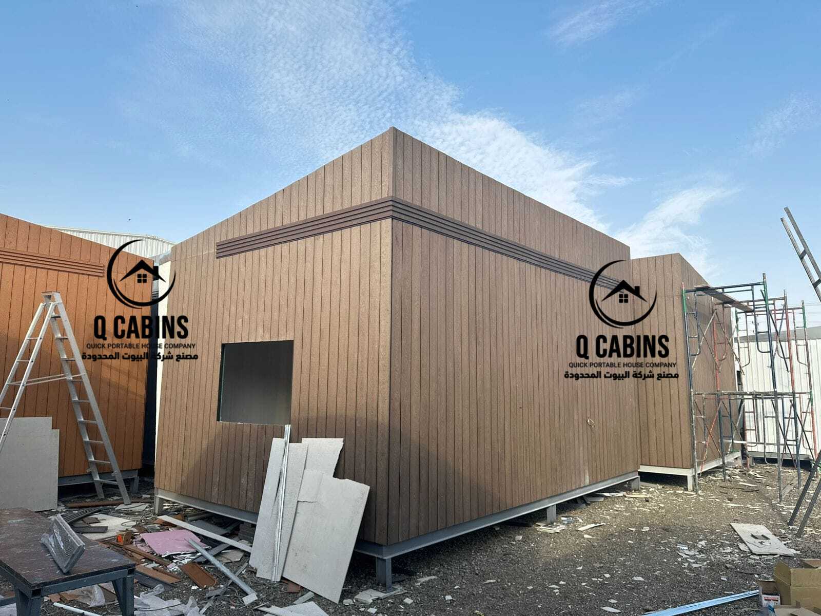 Angle view of a modern prefabricated porta cabin with grey cladding accents and wood cladding