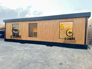 Modern prefabricated house with warm WPC wood plastic composite cladding and exterior lighting