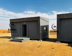 Exterior view of a dark cladding prefabricated room with steps and modern finishes