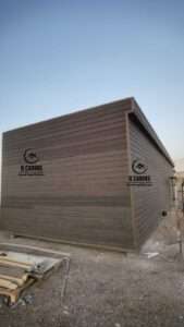 Exterior corner view of a modern prefabricated cabin with wood cladding wall finish