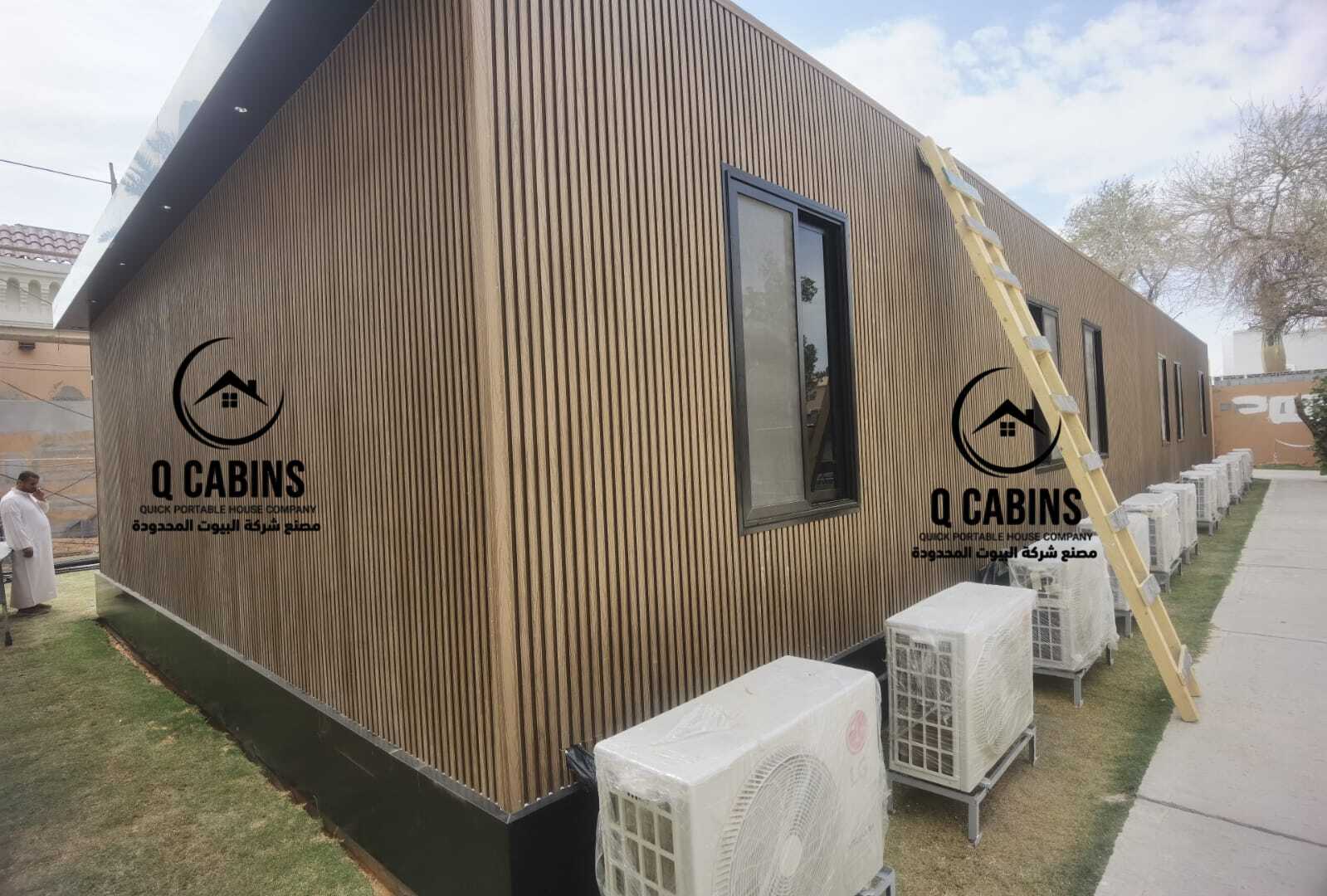 Close-up view of textured WPC wood alternative cladding panels on a prefabricated cabin