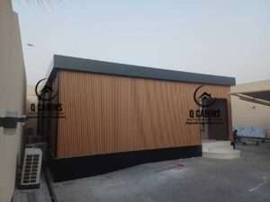 Modern prefabricated room with vertical wood alternative WPC cladding panels and dark border finish