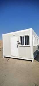 White portable sandwich panel cabin with security window bars and entrance door