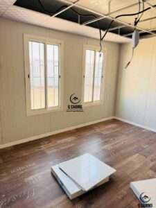 Bright interior of sandwich panel office with wood pattern flooring and double windows