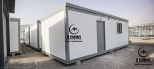 White sandwich panel porta cabin room with dark door and frame installed outdoors