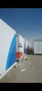 Row of brand new insulated sandwich panel porta cabins with blue branded vinyl wrapping