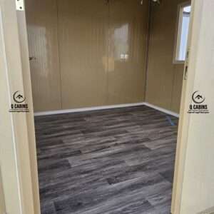 Internal interior of sandwich panel room with dark wood finish flooring
